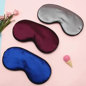 Detailed view of three soft satin sleep eye masks in blue, burgundy, and silver colors.