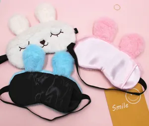 Detailed view of plush rabbit sleep masks showing soft textures and satin backing