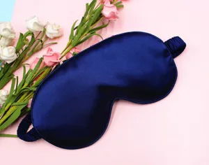 Close-up detail of the smooth satin texture on this luxury navy blue sleep eye mask