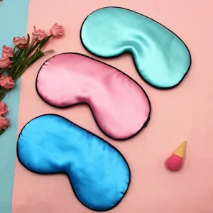 Detailed view of silky satin sleep masks in pink, blue, and turquoise color options