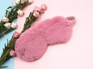 Close-up of a soft pink plush sleep mask featuring a fuzzy faux rabbit fur texture