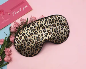 Detailed view of luxury leopard print sleep mask with smooth faux silk texture