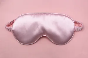 High-quality close-up of the smooth pink silk texture of this breathable sleep eye mask