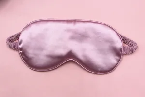 Close-up detailed view of a soft pink satin sleep mask with breathable smooth fabric