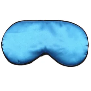 Detailed view of a smooth blue satin sleep mask showing silky texture and black piping.