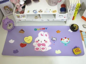 Nahaufnahme einer niedlichen lila Schreibtischunterlage mit großem Comic-Hasen und Desserts.