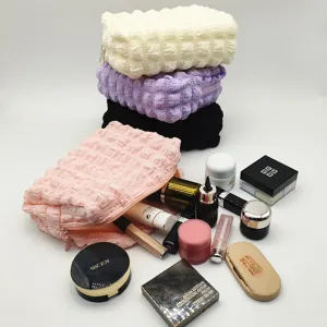 Detail shot of bubble grid cosmetic bags with various makeup items for capacity display