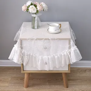 Detailed macro view of elegant white lace dust cover on a vintage wooden bedside table