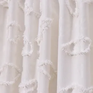 Close-up of white French lace sheer curtain with delicate embroidered circle patterns