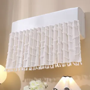 Close-up detail of white lace air conditioner cover with textured tassels and fringe