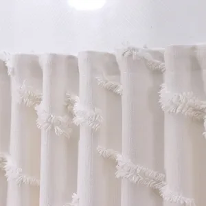 Detailed macro shot of white tufted fringe on elegant French style sheer curtain fabric