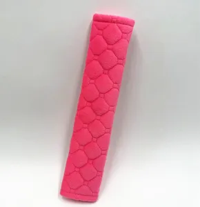 Detail view of the plush texture on a hot pink quilted car seat belt cover