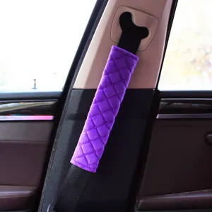 Macro view of purple plush car seat belt cover featuring a quilted rhombus design pattern.