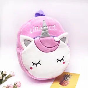 Close-up of a pink plush unicorn backpack with glitter horn and embroidery details