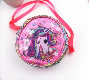 Close-up of pink sequin unicorn crossbody bag with colorful rainbow and glitter details.