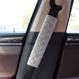 Detail view showing the soft texture and diamond quilting of a grey car seat belt pad
