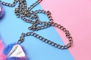 Detailed close-up showing the silver metal chain strap of a colorful unicorn plush bag