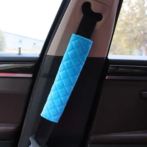 Detail view of a soft blue quilted plush car seat belt shoulder cover for comfort