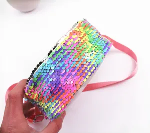 Macro detail showing vibrant rainbow sequins on a crossbody bag for kids and girls.
