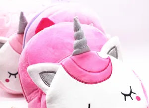 Close-up detail of a cute pink unicorn plush backpack with a silver glitter horn