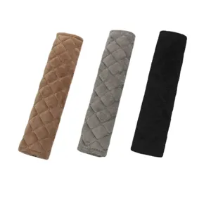 Plush quilted car seat belt shoulder covers in brown, grey, and black colors
