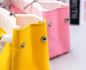 Macro detail of high-quality canvas pencil case featuring durable metal snap buttons