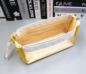Detailed interior view of yellow pencil case with mesh pockets and clear window