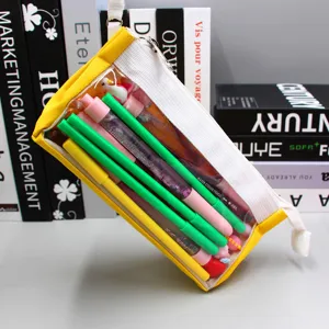 Detail view of transparent yellow pencil case filled with colorful pens and stationery