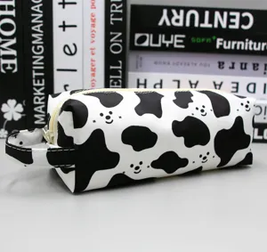 Detailweergave van etui met koeprint, schattig gezichtje en handvat