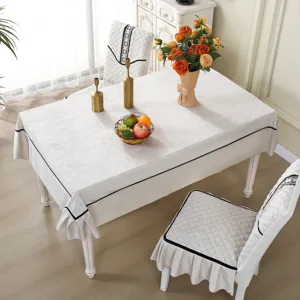 Elegant white quilted dining chair cover set with ruffles and black trim