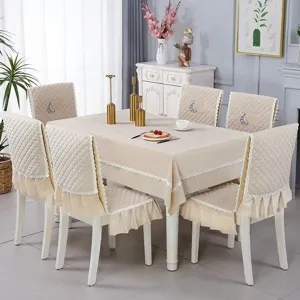 Elegant quilted beige dining tablecloth and chair cover set with sailing boat embroidery.