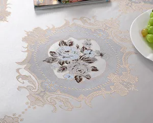 Close-up of elegant floral jacquard pattern on high-quality silver tablecloth.