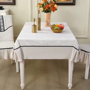 Detail of cream-colored chair cover with elegant ruffle design and black trim accent