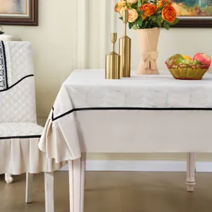 Detailed close-up of the elegant cream-colored ruffled tablecloth and chair cover