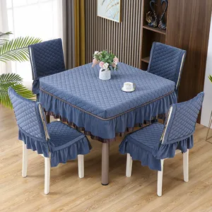 Tovaglia trapuntata blu e set di coprisedia con eleganti volant per la sala da pranzo.