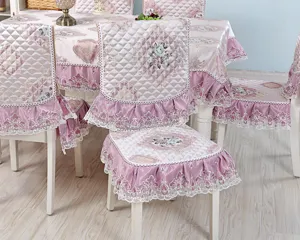 Detail view of quilted dining chair cover with floral pattern and lace ruffles in lavender