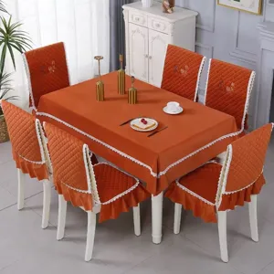 Burnt orange tablecloth and quilted chair cover set with elegant white lace edges