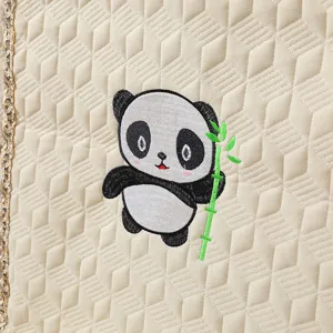 Detailed view of a cute panda embroidery on premium beige quilted dining chair cover fabric