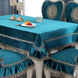Detail of European teal velvet tablecloth and chair covers with elegant gold lace trim