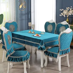 Elegant teal velvet tablecloth and chair cover set with lace in a dining room