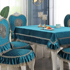 Close-up of teal velvet dining chair and table cover set with elegant lace trim