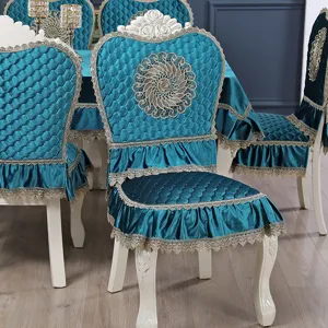 Detail of European peacock blue quilted chair cover with elegant gold lace ruffles.