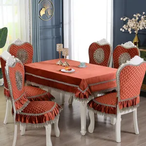 Close-up detail of luxurious orange velvet dining table and chair covers with elegant lace trim