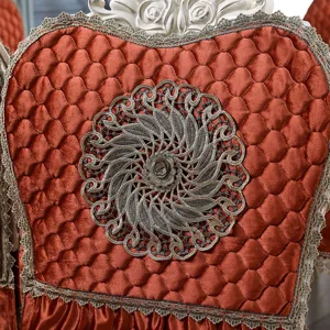 Close-up of European style orange velvet chair cover with lace and embroidery