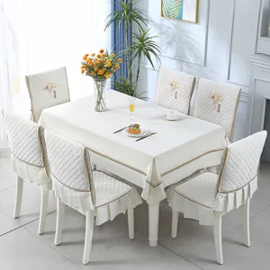 Elegant white dining tablecloth and quilted chair cover set with embroidered detail