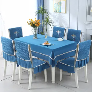 Dining set with blue quilted tablecloth and matching ruffled chair covers