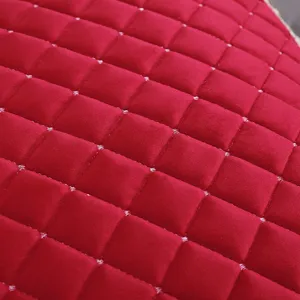 Gros plan sur un tissu matelassé en velours rouge pour coussin de chaise chic.