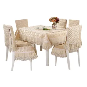 Elegant champagne quilted dining table cloth and chair cover set with intricate lace trim details