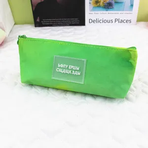 Detailed view of the vibrant green tie-dye pencil case with a clear decorative patch.
