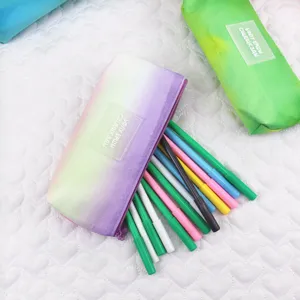Detailed macro view of a tie-dye gradient stationery bag filled with colorful markers